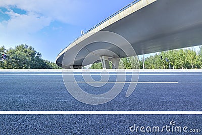 Asphalt roads and city buildings under the overpass, automobile advertising road material. Stock Photo